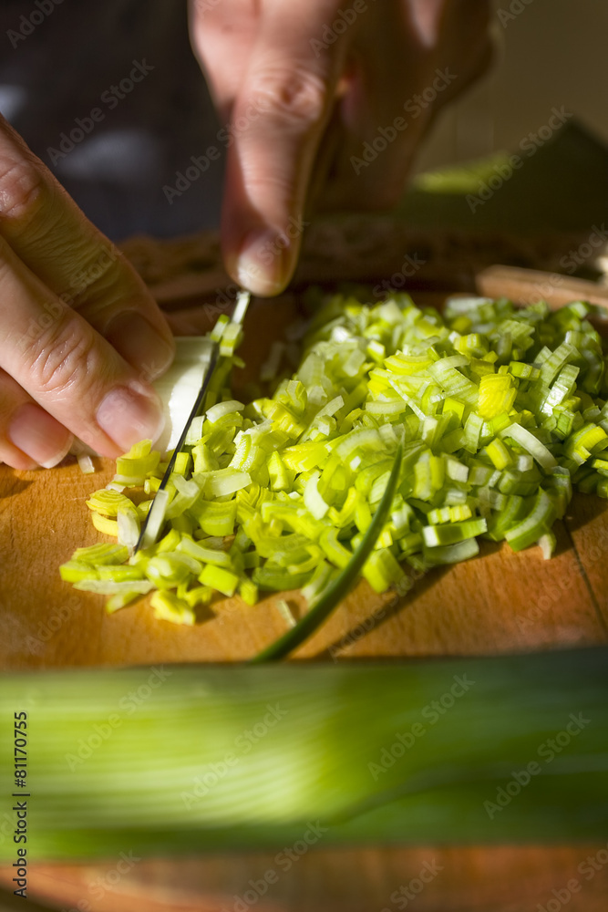 Woman cut fresh vegetables on wooden board Woman cut fresh vegetables on wooden board