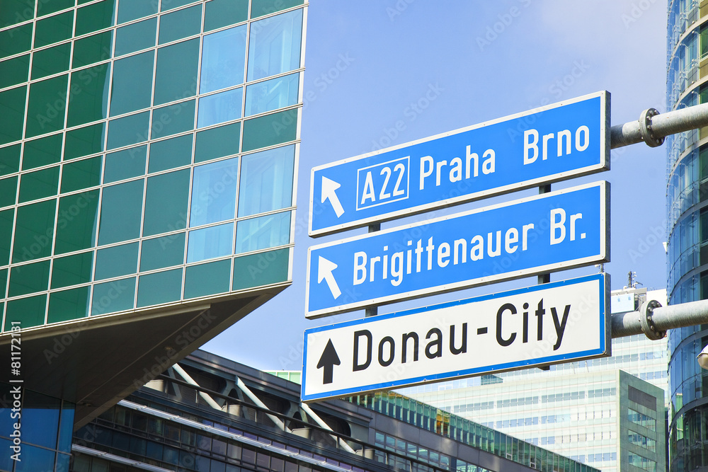 Obraz premium Donau City roadsign on blue background (Wien - Austria)