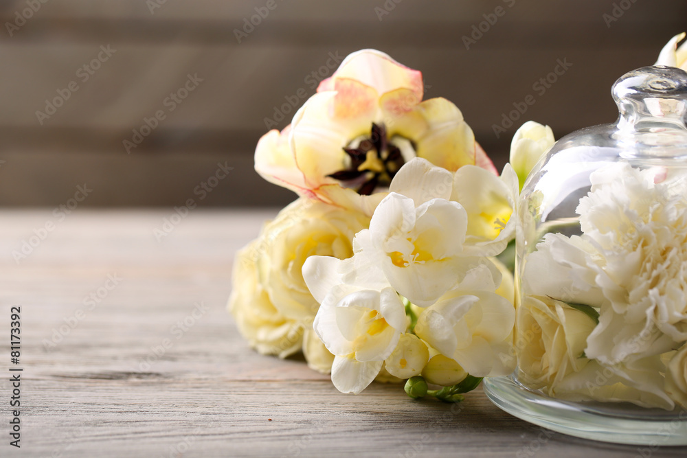 Beautiful composition with flowers on grey wooden background Beautiful composition with flowers on grey wooden background