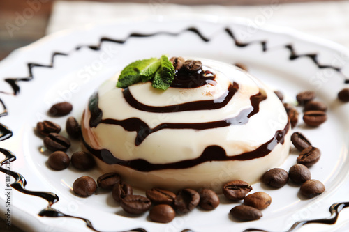 Tasty panna cotta dessert on plate, close up