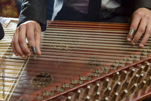 Fingers Playing Arabian Qanun Musical Instrument photo