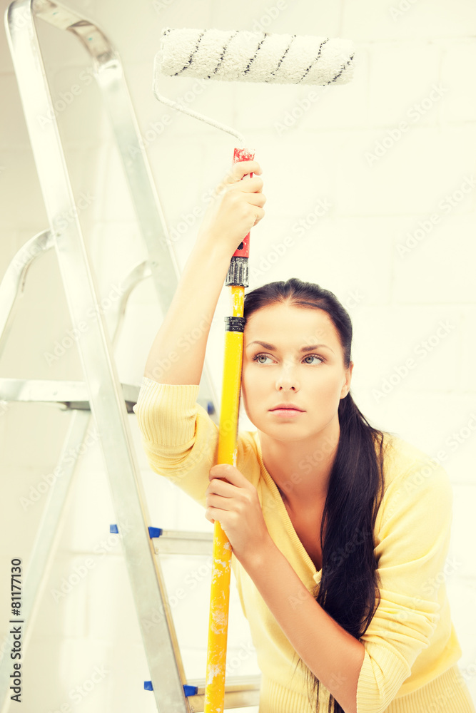 bored and tired young woman with paintroller bored and tired young woman with paintroller