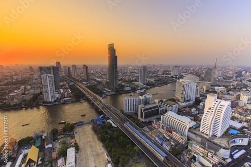 River in Bangkok city with high office building at sunset