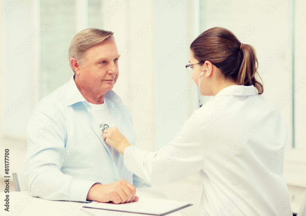 Fototapeta premium female doctor with old man listening to heart beat