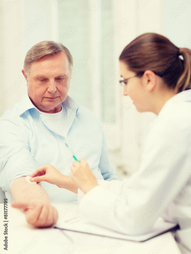 female doctor doing injection to old man female doctor doing injection to old man