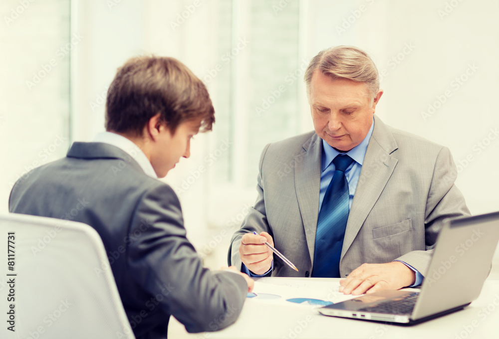 older man and young man having meeting in office older man and young man having meeting in office