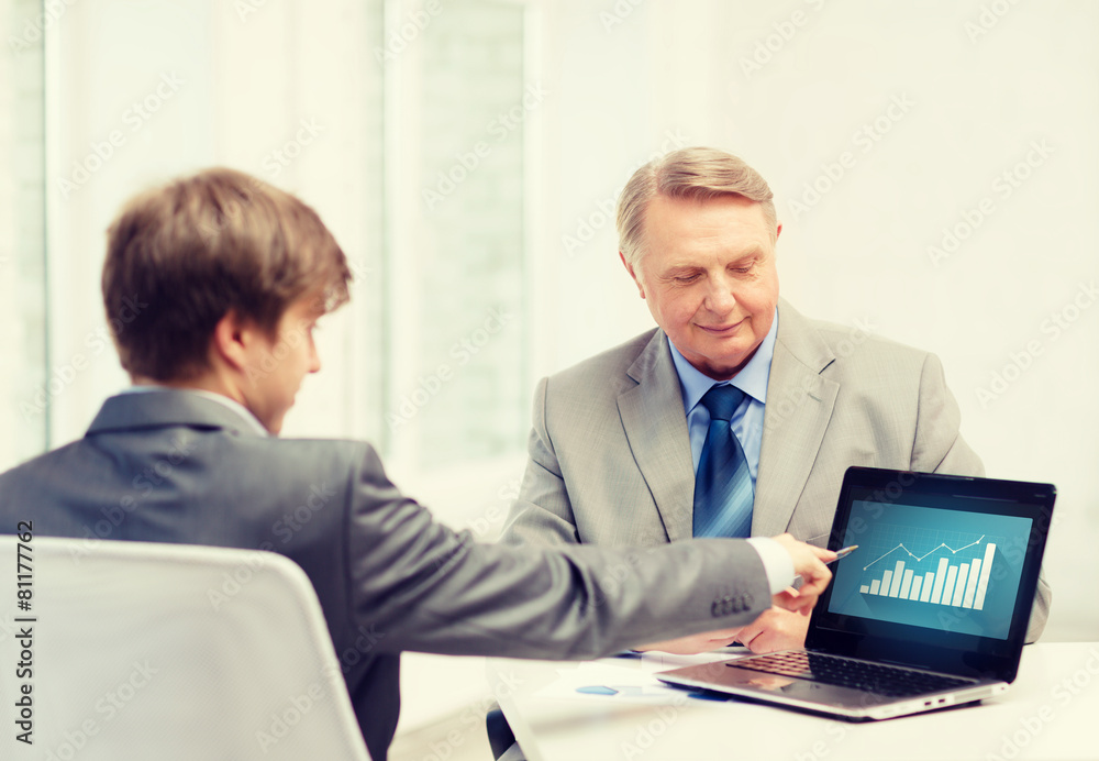older man and young man with laptop computer