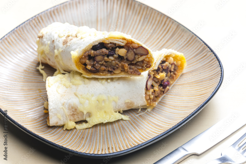 burrito filled with beef minced meat and beans baked with gouda