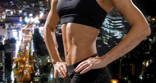 close up of athletic female abs in sportswear