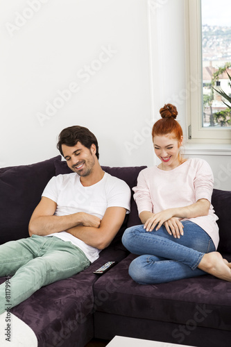 Happy Young Sweet Couple Sitting at the Couch © juniart