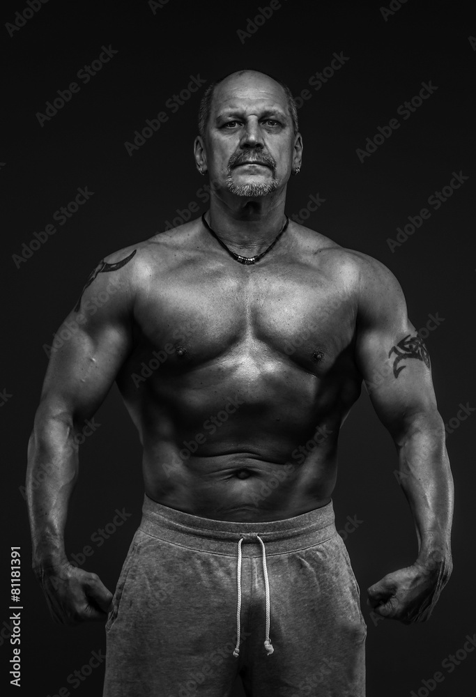 Muscular middle age man showing his muscules