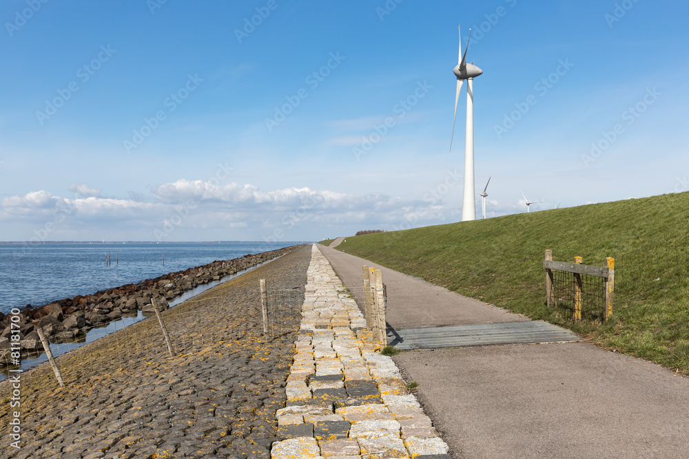Dutch coastline with dike and wind turbines