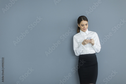 Young woman by the wall