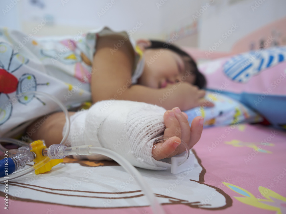 little girl on a drip receiving a saline solution little girl on a drip receiving a saline solution