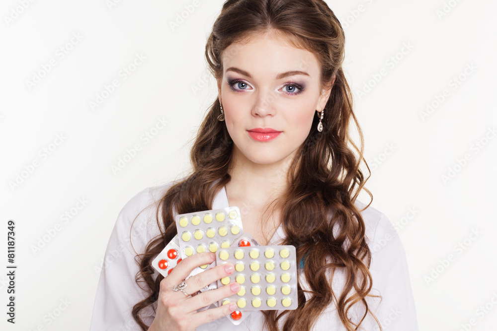 Pretty nurse with vitamins isolated on white Pretty nurse with vitamins isolated on white