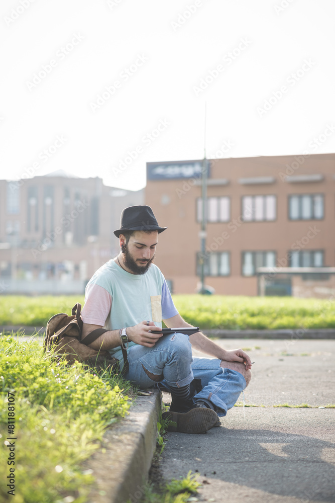 Fototapeta premium young handsome hipster gay modern man using tablet