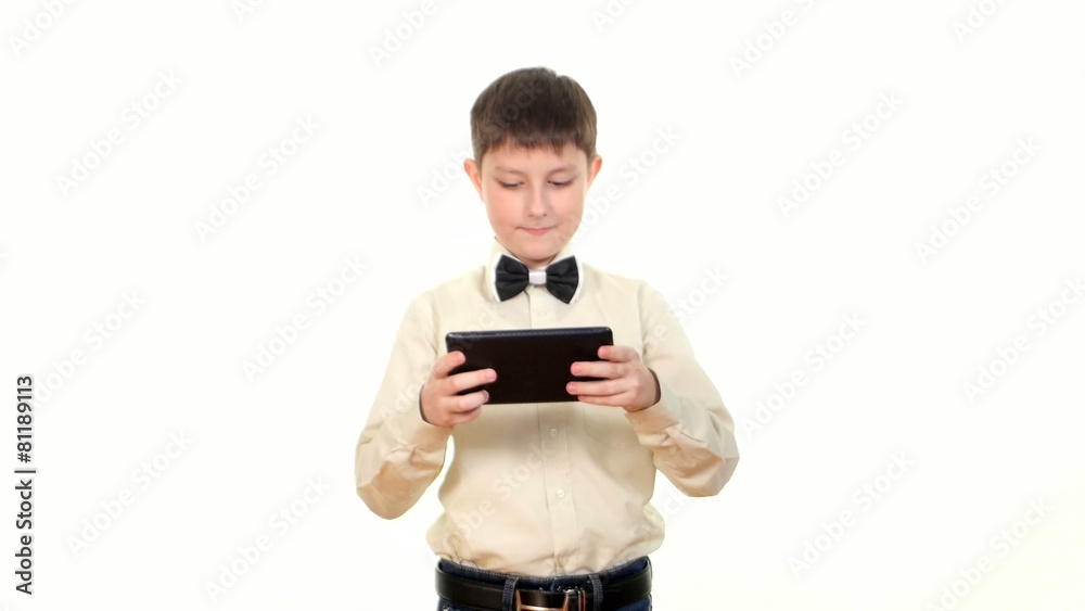 School boy playing something using tablet computer, on white School boy playing something using tablet computer, on white