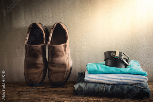 Still life with casual man on wooden tabletop against grunge wal