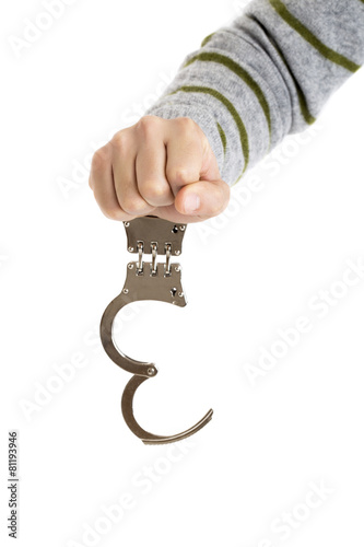Closeup of unlocked handcuffs hanging on man hand