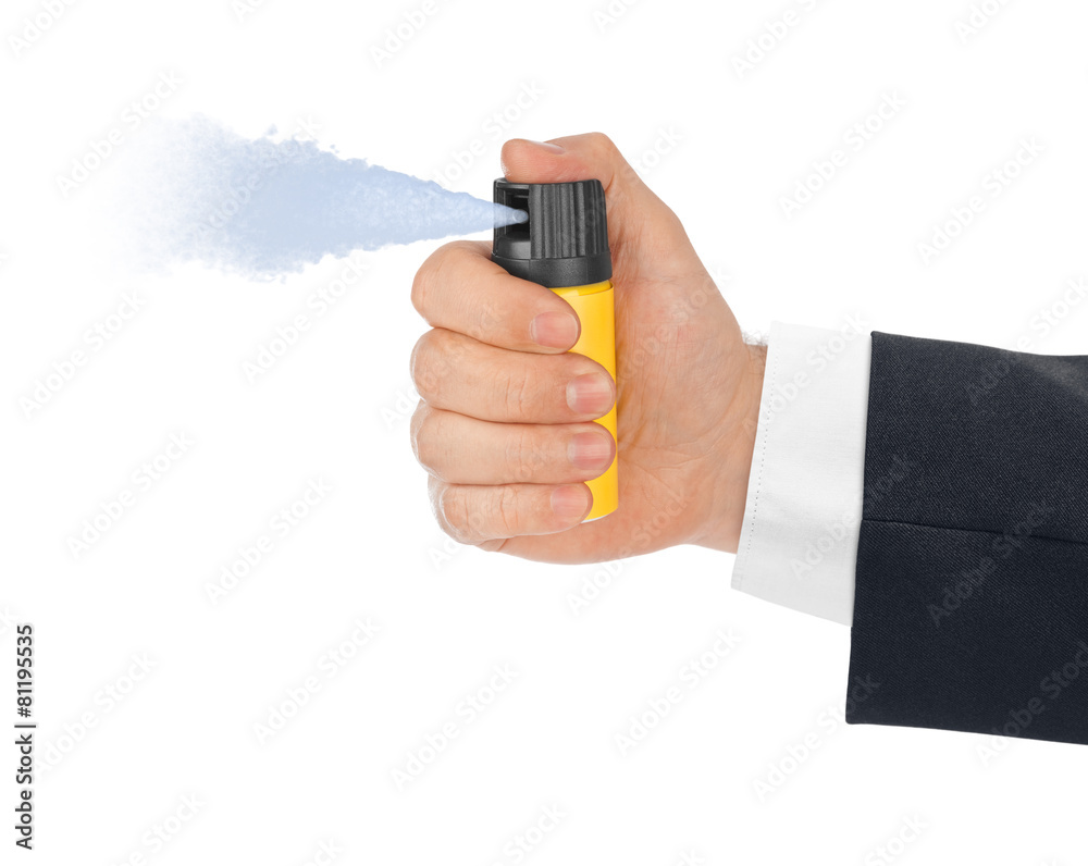 Hand with bottle of pepper spray Hand with bottle of pepper spray