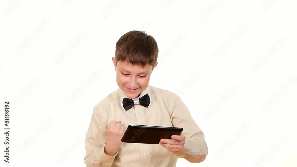 Clever, smart school boy playing using tablet computer, on white Clever, smart school boy playing using tablet computer, on white