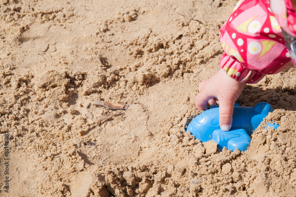 Children's hand in the sandbox Children's hand in the sandbox