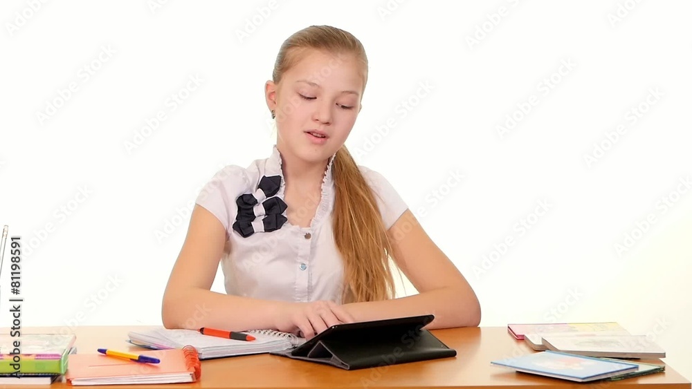 School girl taught lessons using the tablet computer doing School girl taught lessons using the tablet computer doing