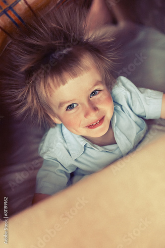 Little boy with electrified hair under bluncket.  Grain added.