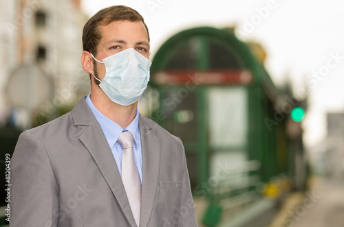 young man walking wearing a mask in city street concept of