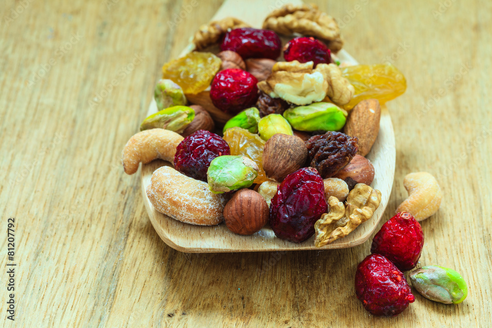 Varieties of dried fruits and nuts on wooden spoon. Varieties of dried fruits and nuts on wooden spoon.