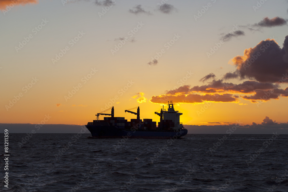 Ship underway at sunset