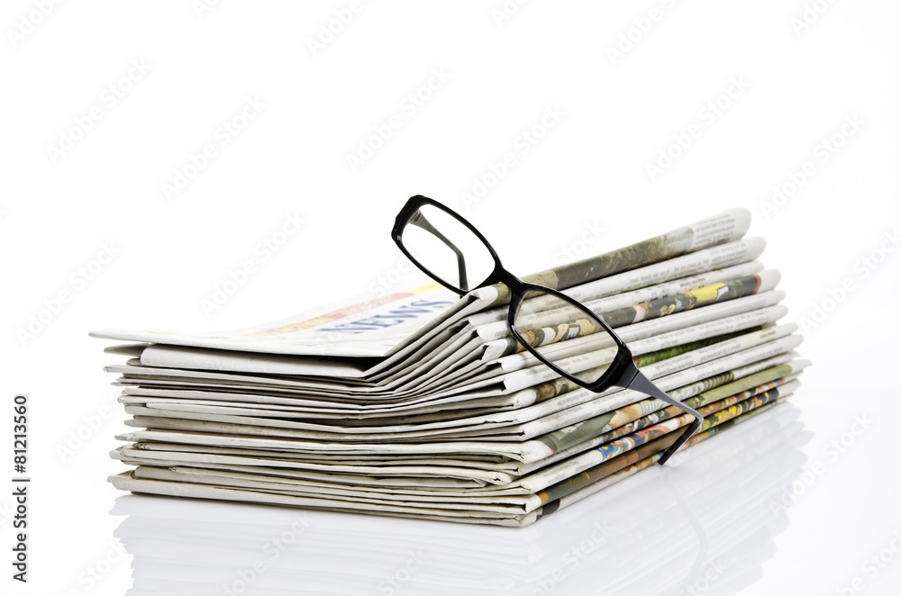 glasses on newspaper with white background glasses on newspaper with white background