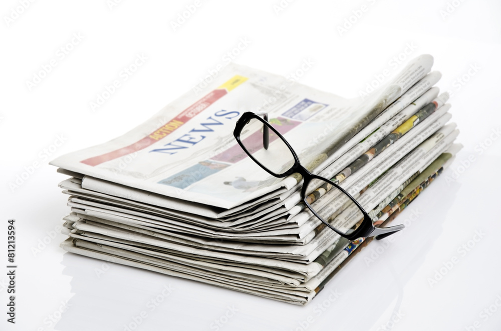 bird eye view of glasses on newspapers against white background bird eye view of glasses on newspapers against white background