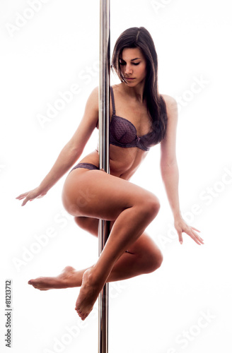 Beautiful young woman exercise pole dance against a white backgr © kasjato