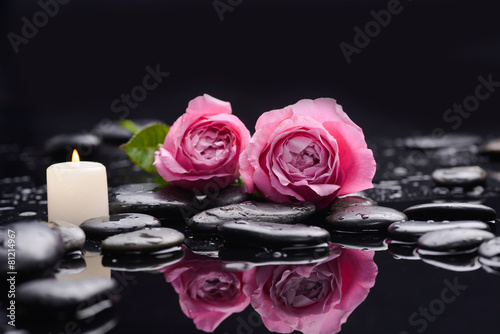 Beautiful rose with candle and therapy stones