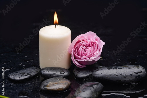 pink rose with candle and therapy stones