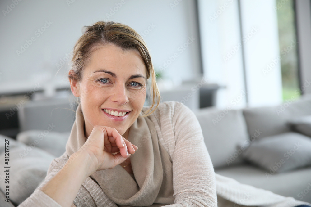 Fototapeta premium Portrait of mature woman relaxing in sofa