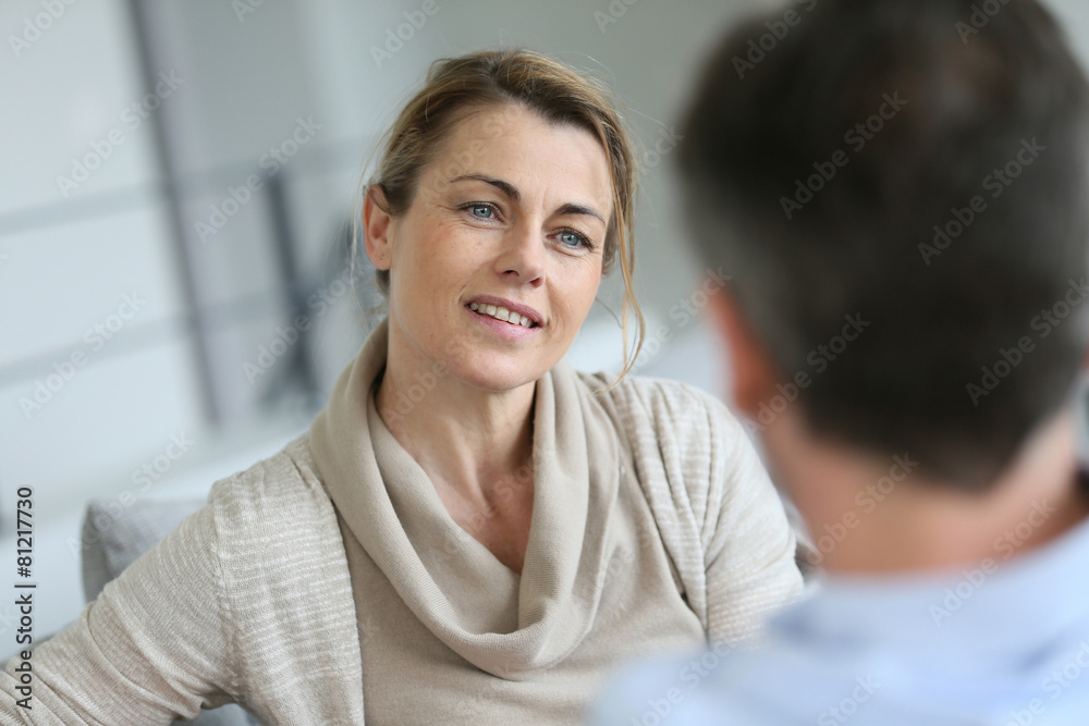 Couple at home sitting in sofa and having a talk