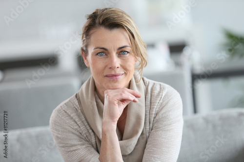 Portrait of smiling mature woman with hand on chin
