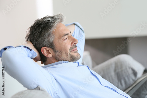 Photography Middle-aged man having a restful moment relaxing in sofa