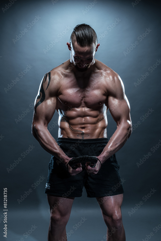 Topless Muscular Man Bending an Exercise Bar