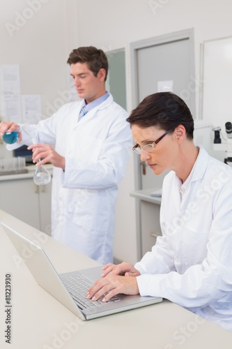 Scientist working attentively with laptop