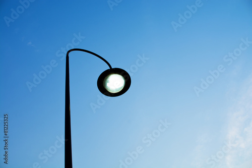 Street electric lamp on blue sky background