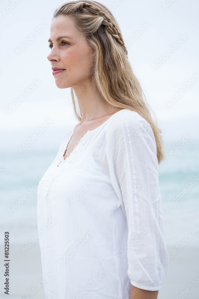 Smiling blonde standing by the sea Smiling blonde standing by the sea