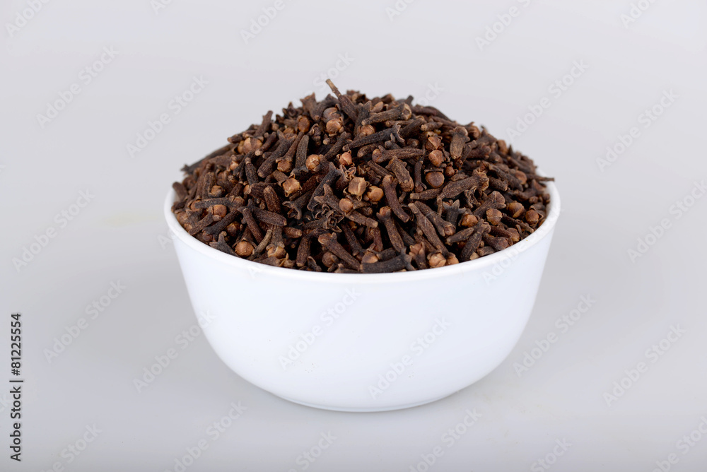 Cloves in white bowl with white background Cloves in white bowl with white background