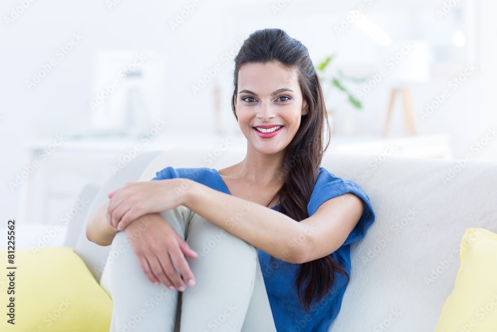 Smiling beautiful brunette relaxing on the couch Smiling beautiful brunette relaxing on the couch