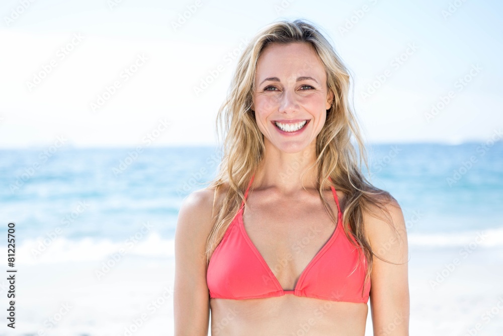 Smiling blonde in bikini looking at camera