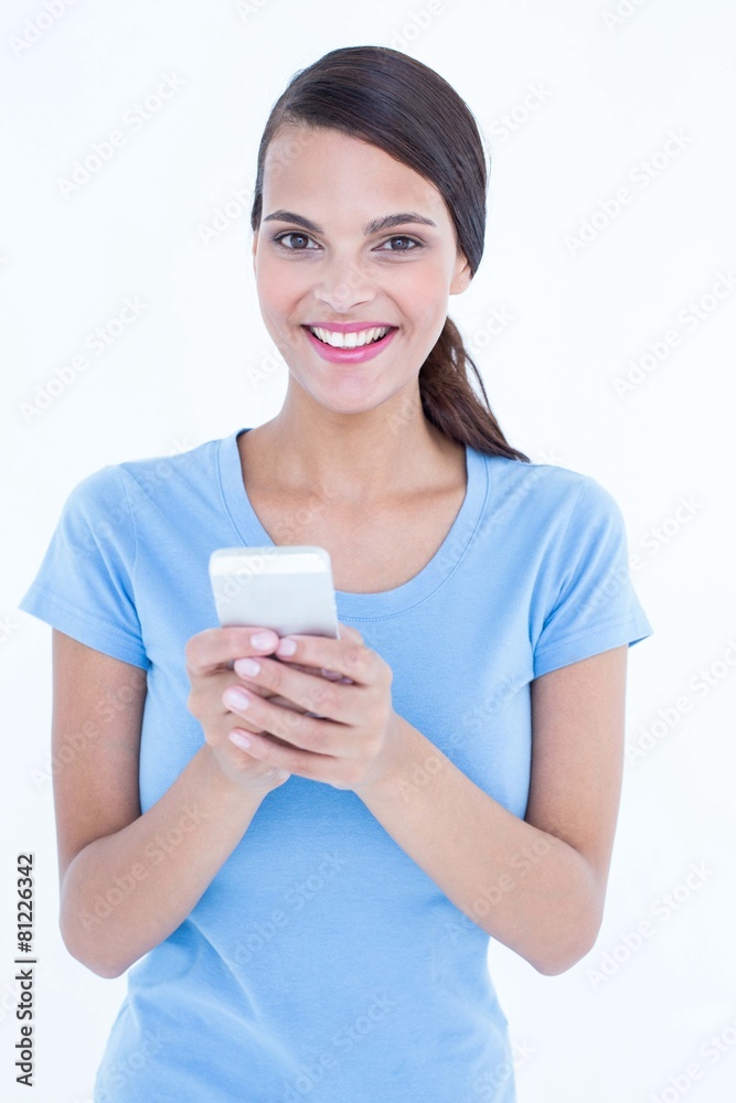 Happy brunette looking at her smartphone Happy brunette looking at her smartphone