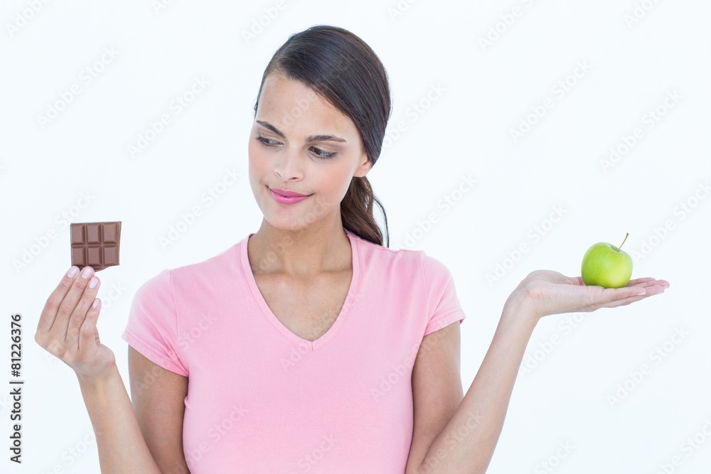 Pretty woman holding chocolate bars and an apple Pretty woman holding chocolate bars and an apple