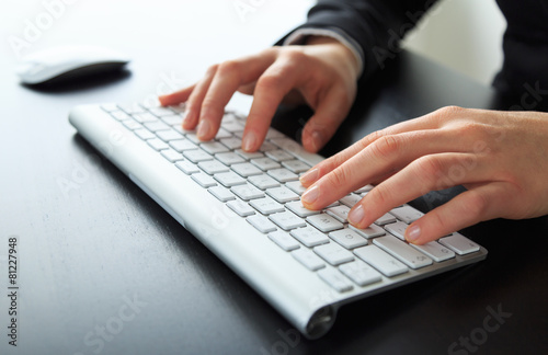 Close-up of female hands at a keyboard/computer. Shallow DOF.